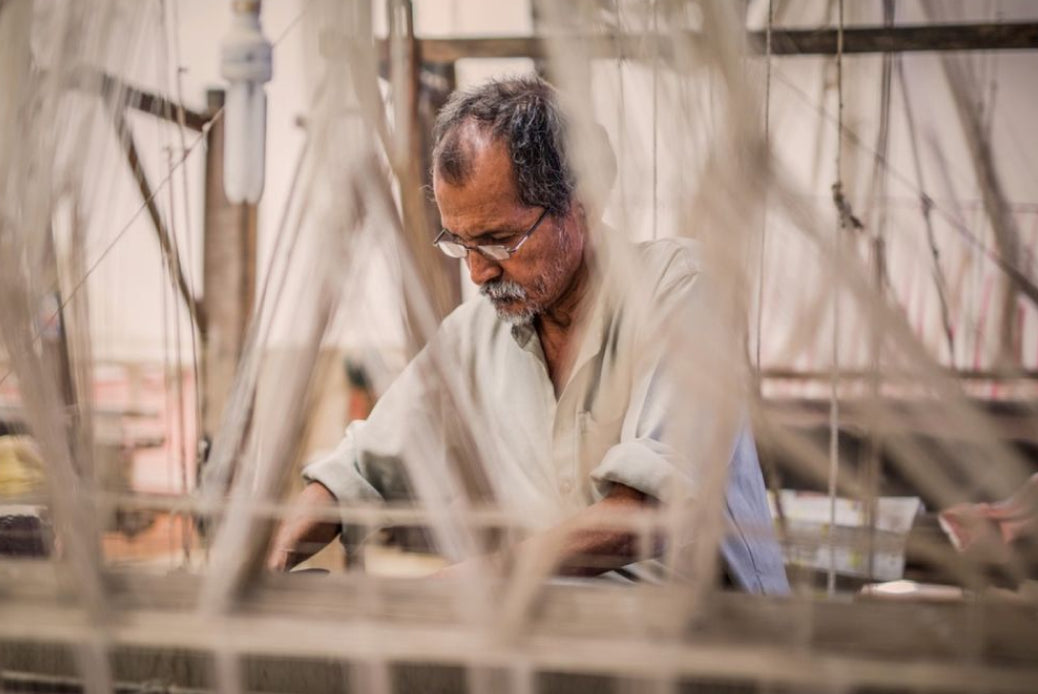 Handloom weaver working on a traditional loom